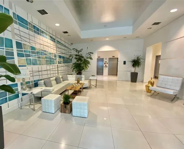 a lobby with furniture and a potted plant