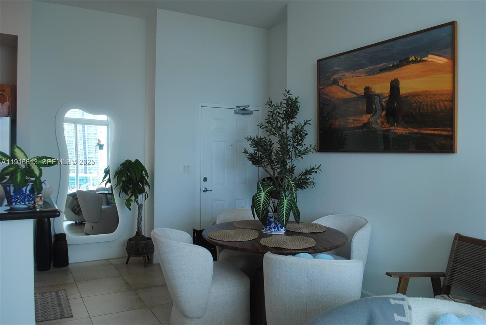 1723 Southwest 2nd Avenue, Unit PH09 Miami, FL 33129 - Photo 6 of 21 a potted plant sitting on a table and chair