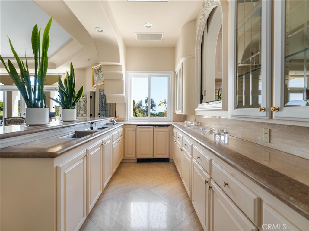 6000 Cavalleri Road Malibu, CA 90265 - Photo 20 of 44 a large white kitchen with a sink and a large window
