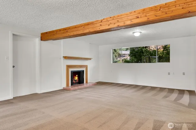 a view of an empty room with a fireplace