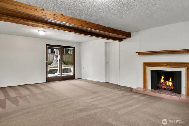 a view of an empty room with a fireplace
