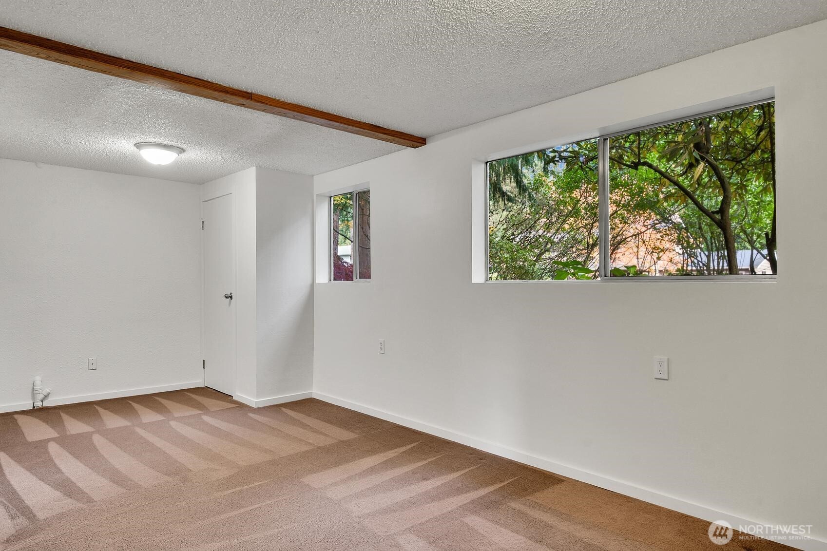 19414 1st Avenue Southeast Bothell, WA 98012 - Photo 23 of 27 a view of empty room with wooden floor and fan