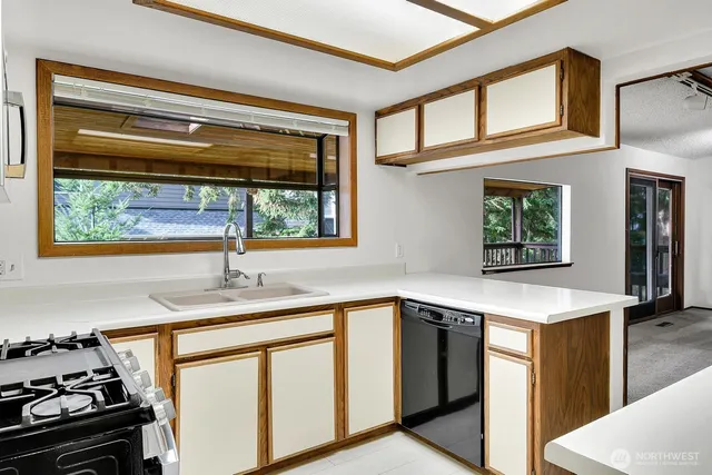 a kitchen with stainless steel appliances granite countertop a sink and a stove