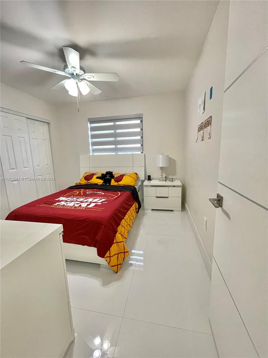 13850 Southwest 22nd Street Miami, FL 33175 - Photo 11 of 23 a bedroom with a bed and a chandelier