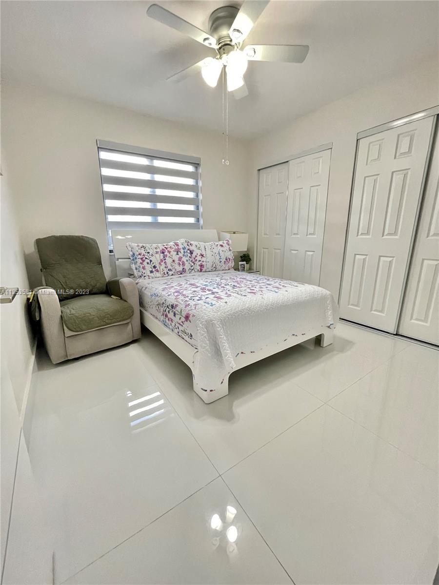 13850 Southwest 22nd Street Miami, FL 33175 - Photo 12 of 23 a bedroom with a bed couch and window