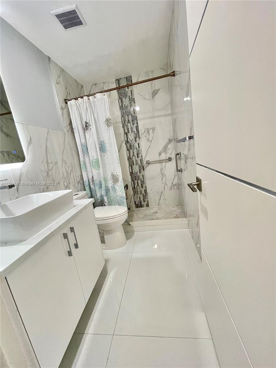 13850 Southwest 22nd Street Miami, FL 33175 - Photo 13 of 23 a bathroom with a sink a toilet and shower