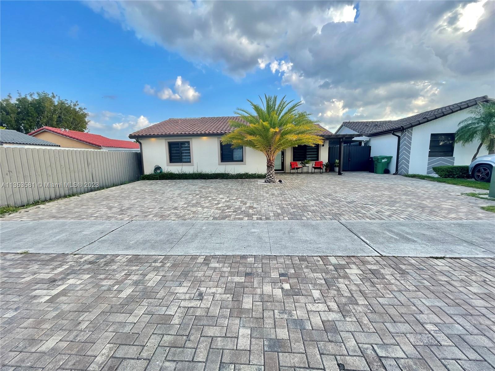 13850 Southwest 22nd Street Miami, FL 33175 - Photo 16 of 23 a view of a house with a yard and garage