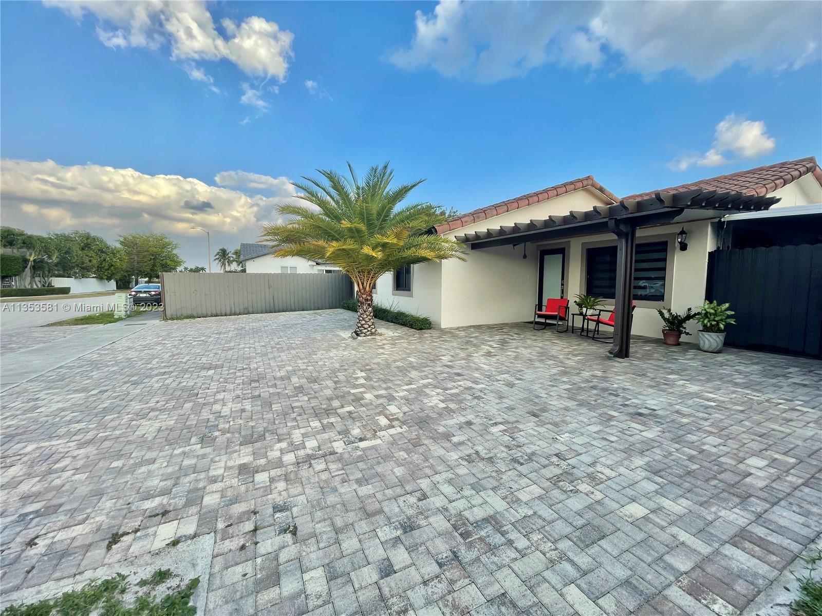13850 Southwest 22nd Street Miami, FL 33175 - Photo 17 of 23 a front view of a house with garden