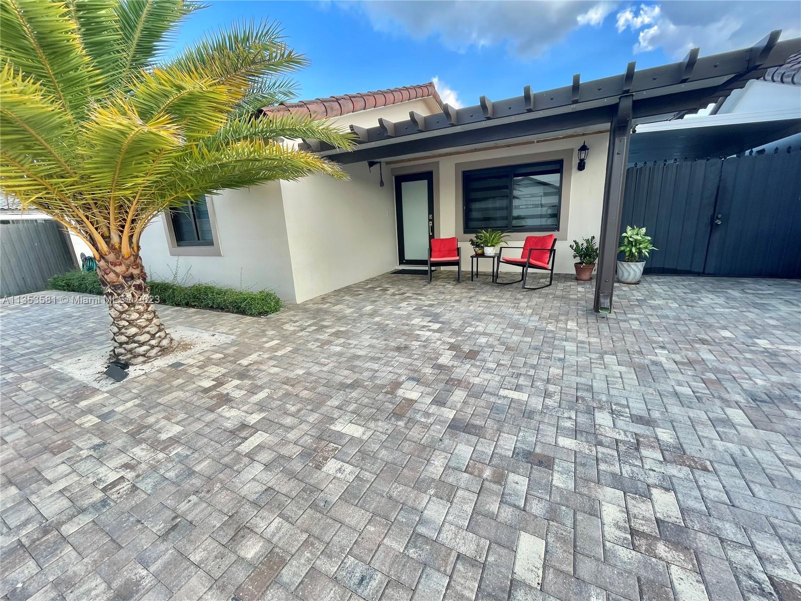 13850 Southwest 22nd Street Miami, FL 33175 - Photo 18 of 23 a backyard of a house with barbeque oven table and chairs