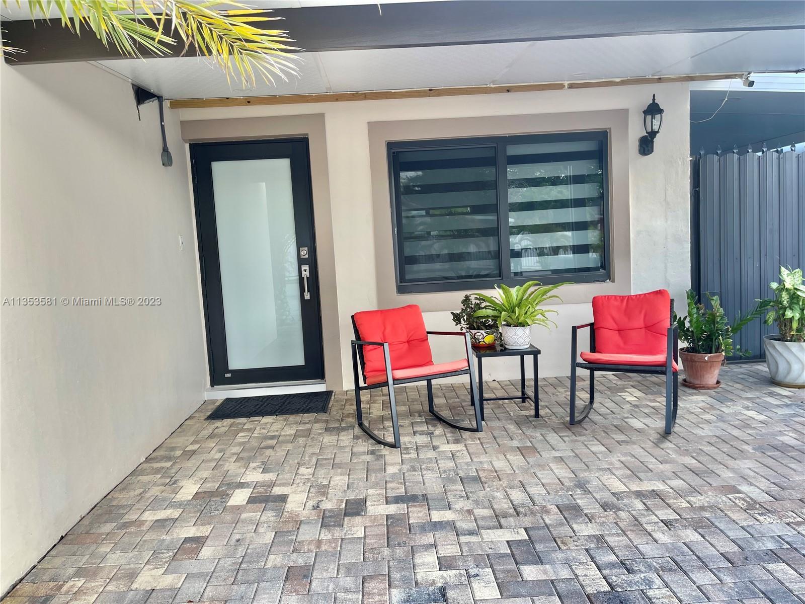 13850 Southwest 22nd Street Miami, FL 33175 - Photo 19 of 23 a building outdoor space with patio furniture and potted plants