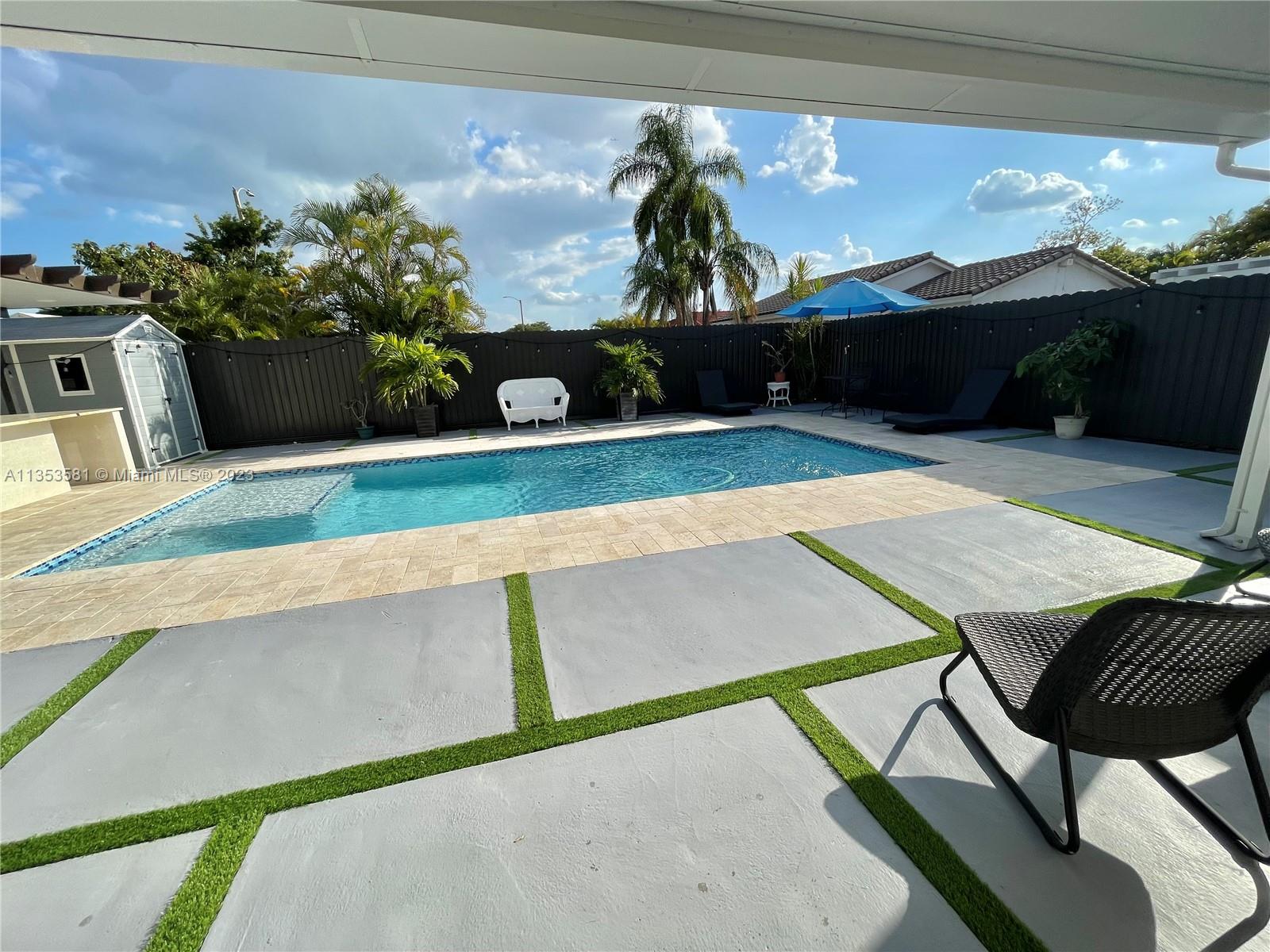 13850 Southwest 22nd Street Miami, FL 33175 - Photo 20 of 23 a front view of a house with a yard