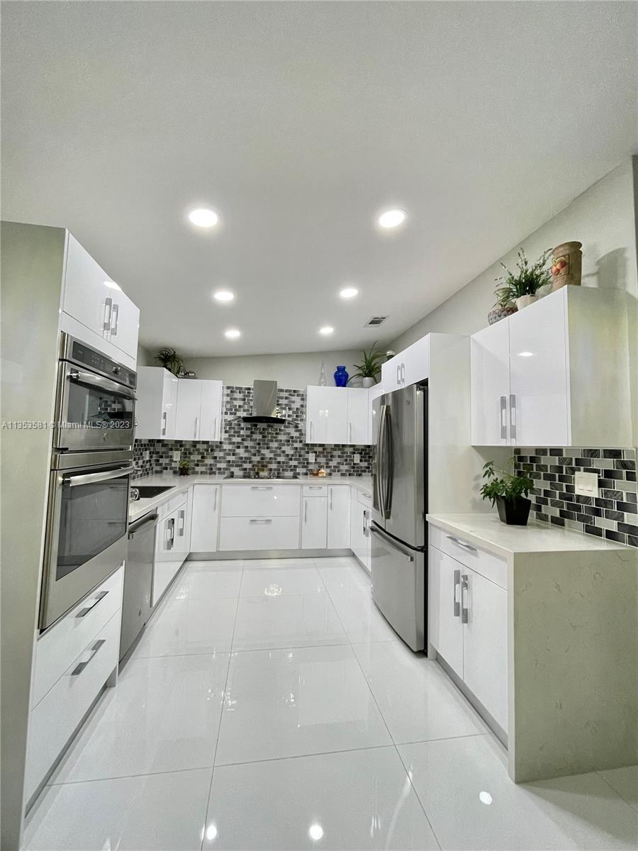 13850 Southwest 22nd Street Miami, FL 33175 - Photo 4 of 23 a kitchen with stainless steel appliances a refrigerator sink and stove top oven