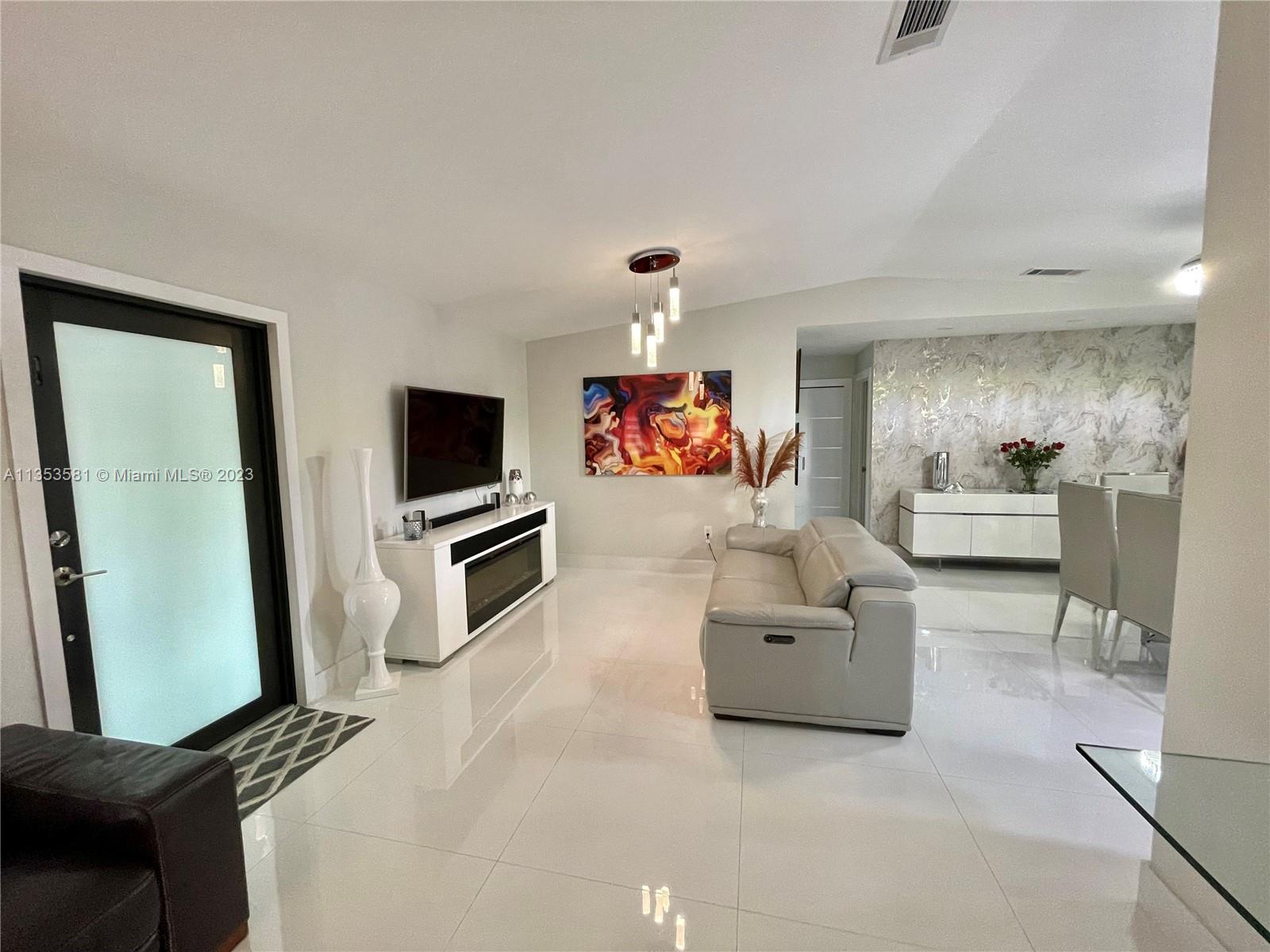 13850 Southwest 22nd Street Miami, FL 33175 - Photo 5 of 23 a living room with furniture and a flat screen tv