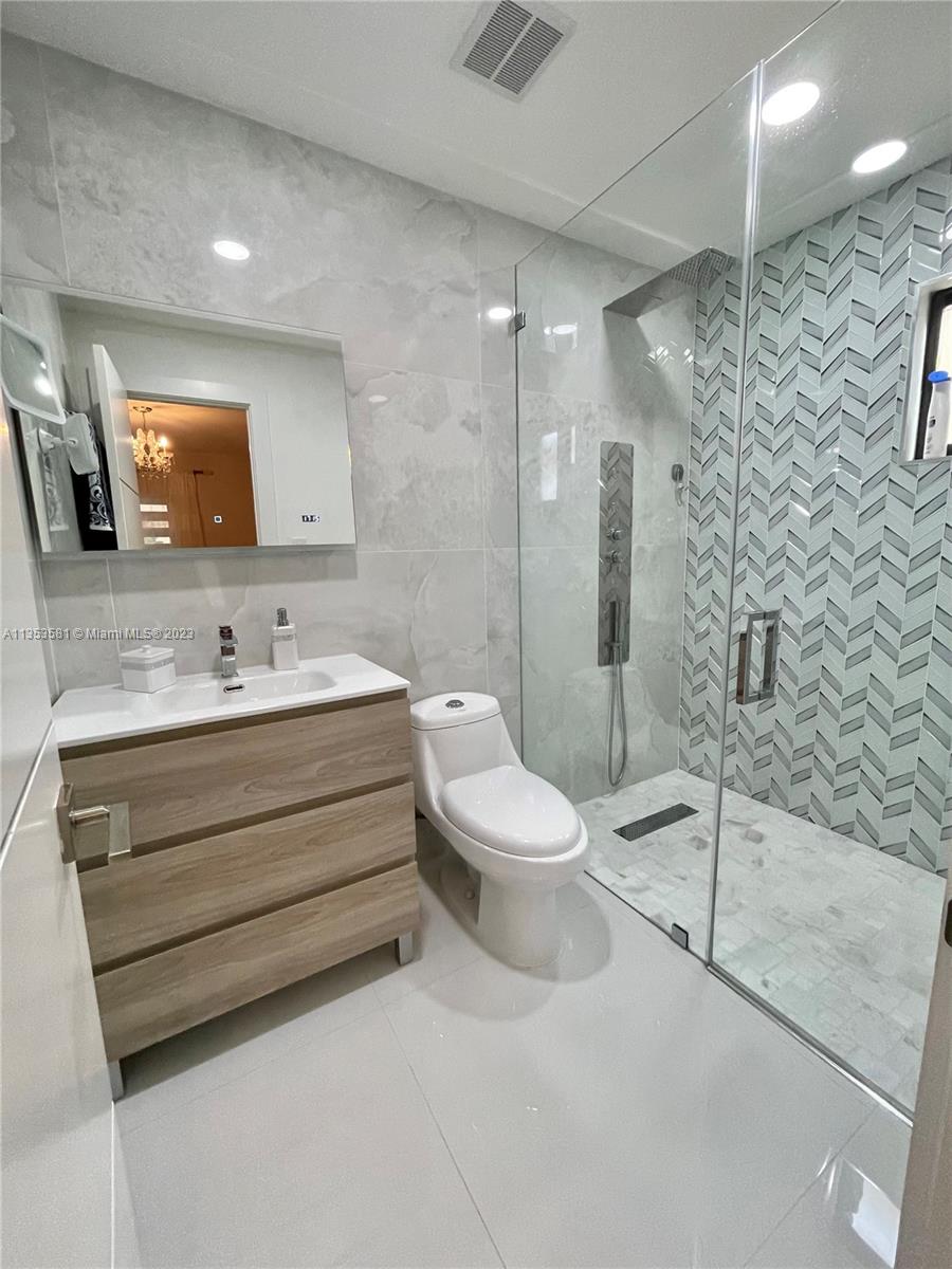 13850 Southwest 22nd Street Miami, FL 33175 - Photo 8 of 23 a bathroom with a toilet sink and shower