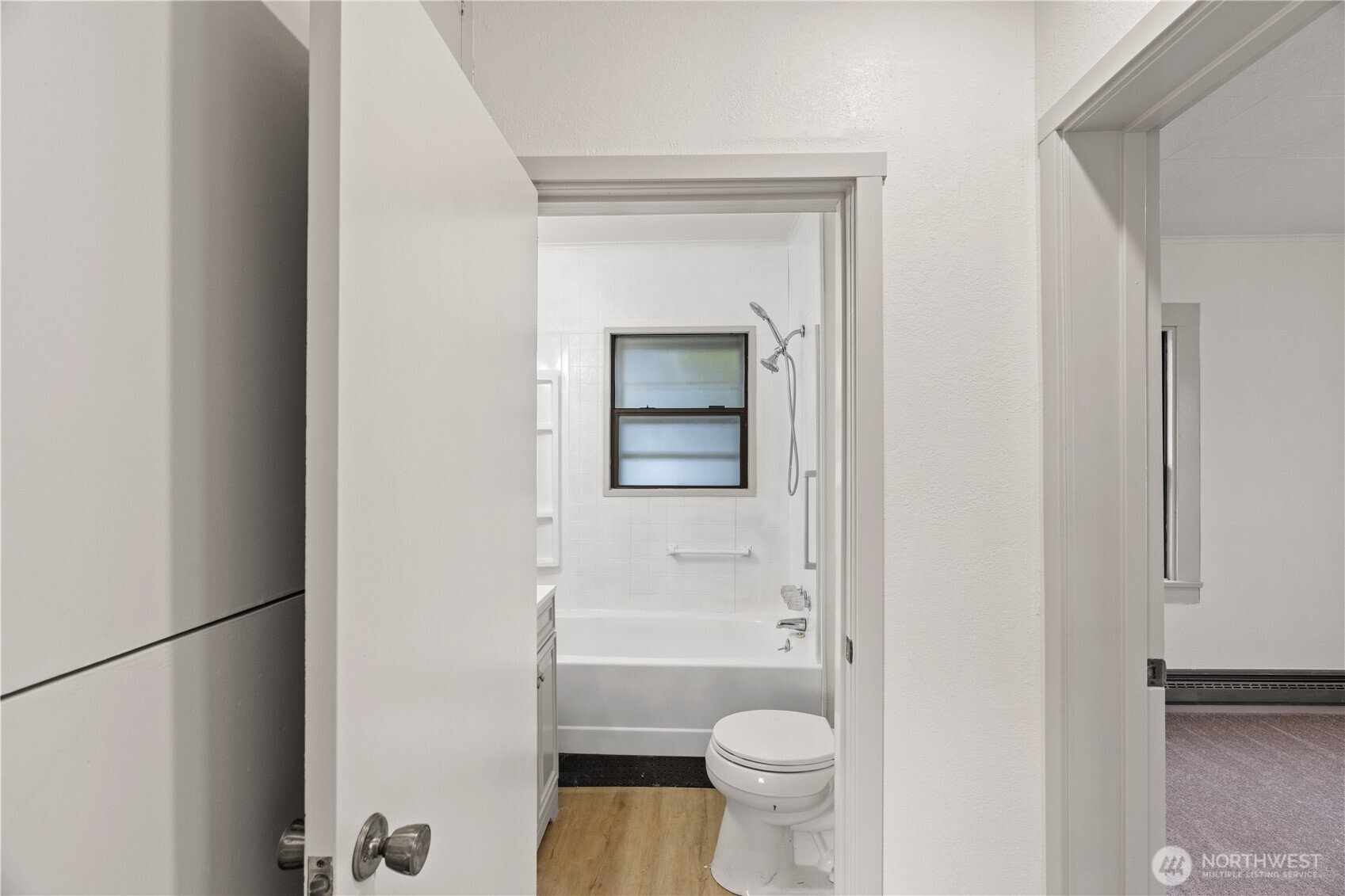 3003 Sumner Avenue Hoquiam, WA 98550 - Photo 11 of 26 a bathroom with a granite countertop toilet and a sink