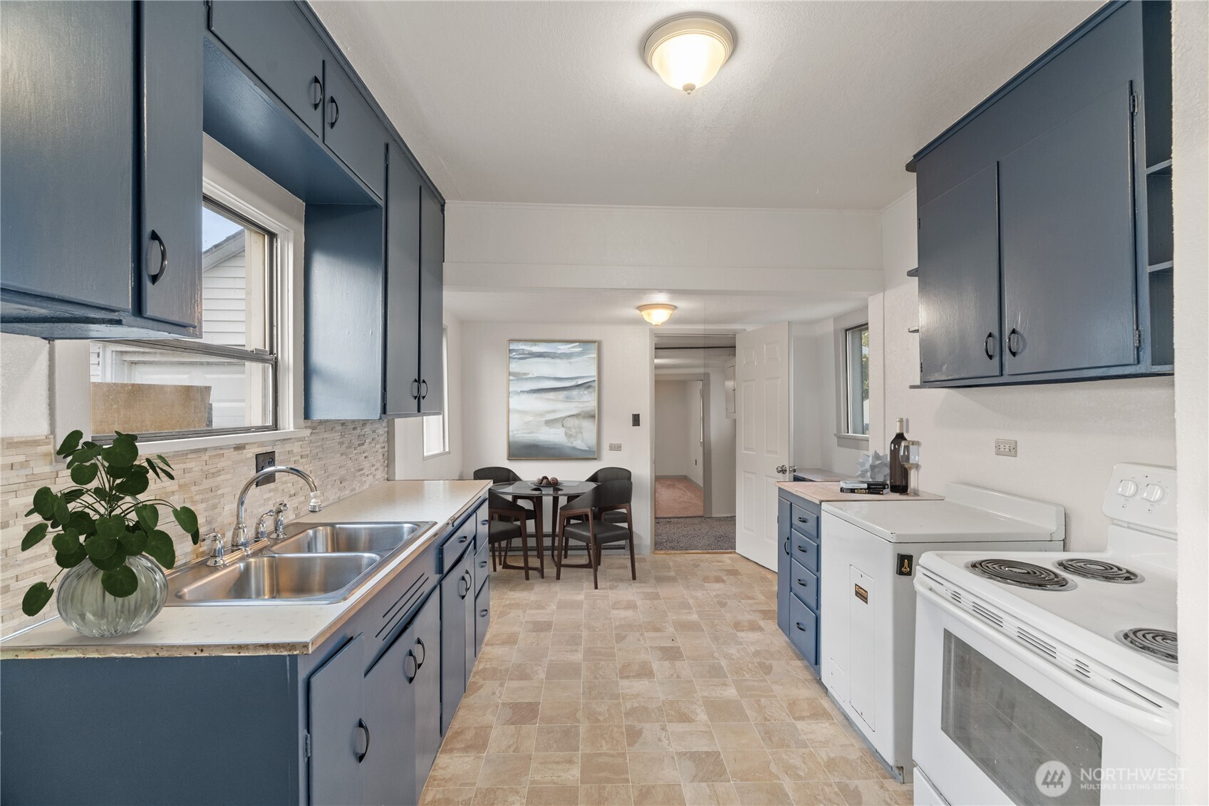 3003 Sumner Avenue Hoquiam, WA 98550 - Photo 6 of 26 a kitchen with a sink stove and cabinets