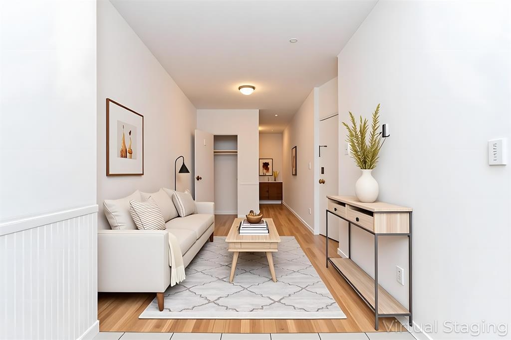 118 Adams Street, Unit 6 Hoboken, NJ 07030 - Photo 1 of 17 a living room with furniture a rug and a chandelier