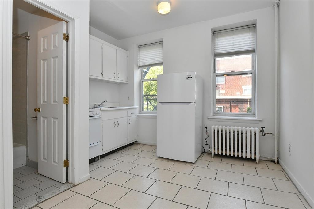 118 Adams Street, Unit 6 Hoboken, NJ 07030 - Photo 15 of 17 a view of a kitchen with cabinets and window