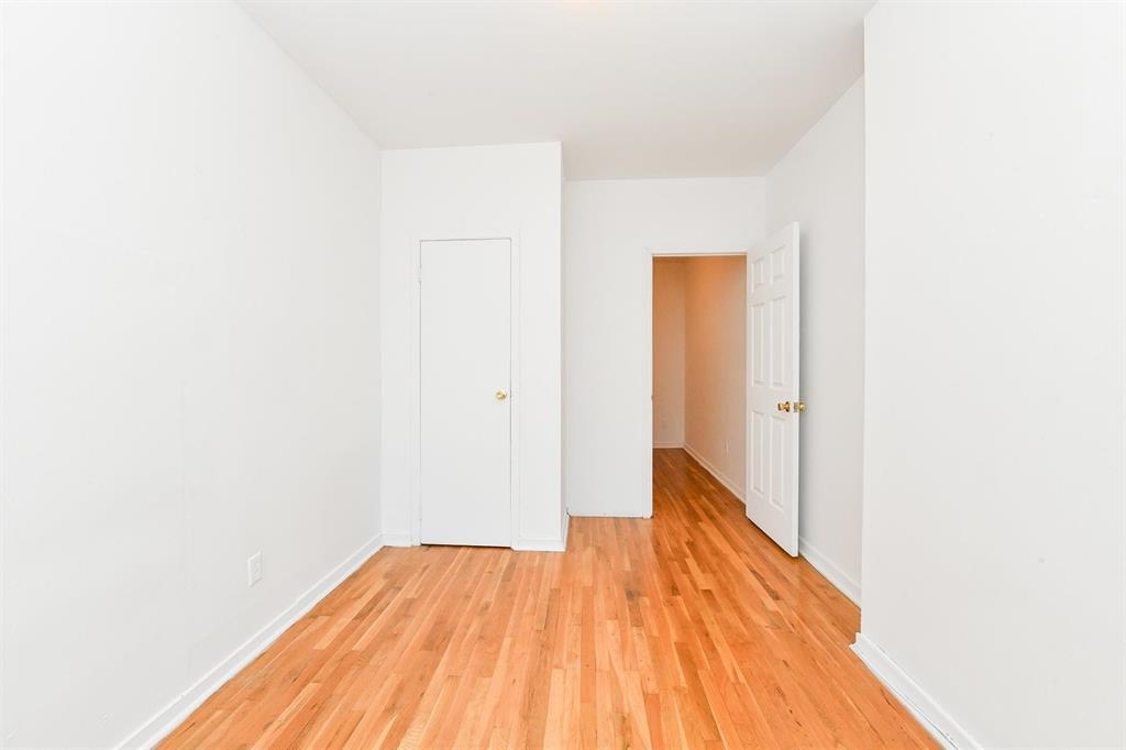 118 Adams Street, Unit 6 Hoboken, NJ 07030 - Photo 3 of 17 a view of a room with wooden floor and a ceiling fan