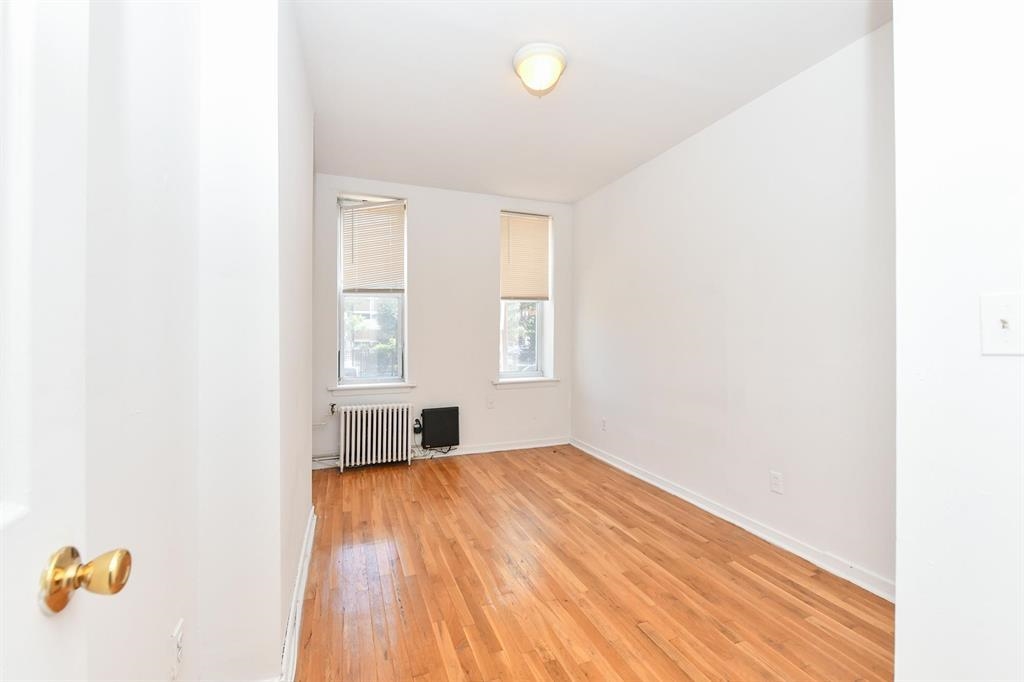118 Adams Street, Unit 6 Hoboken, NJ 07030 - Photo 9 of 17 a view of empty room with wooden floor and fan