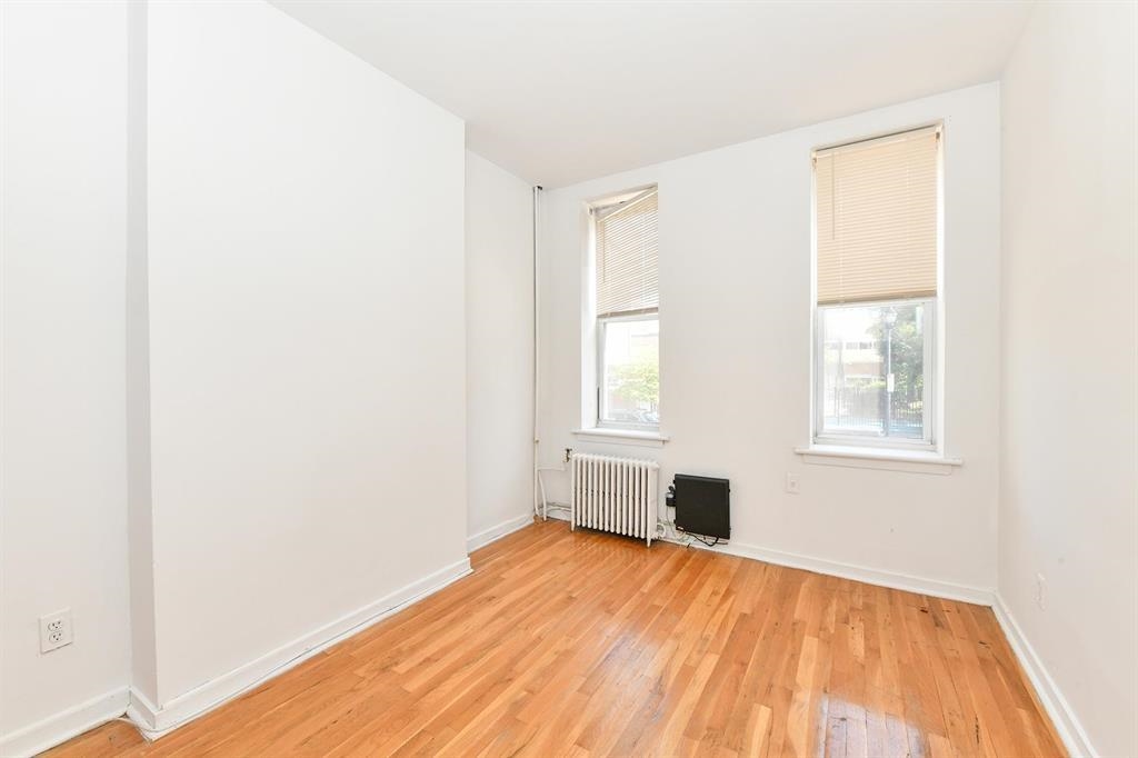 118 Adams Street, Unit 6 Hoboken, NJ 07030 - Photo 10 of 17 a view of empty room with wooden floor and fan