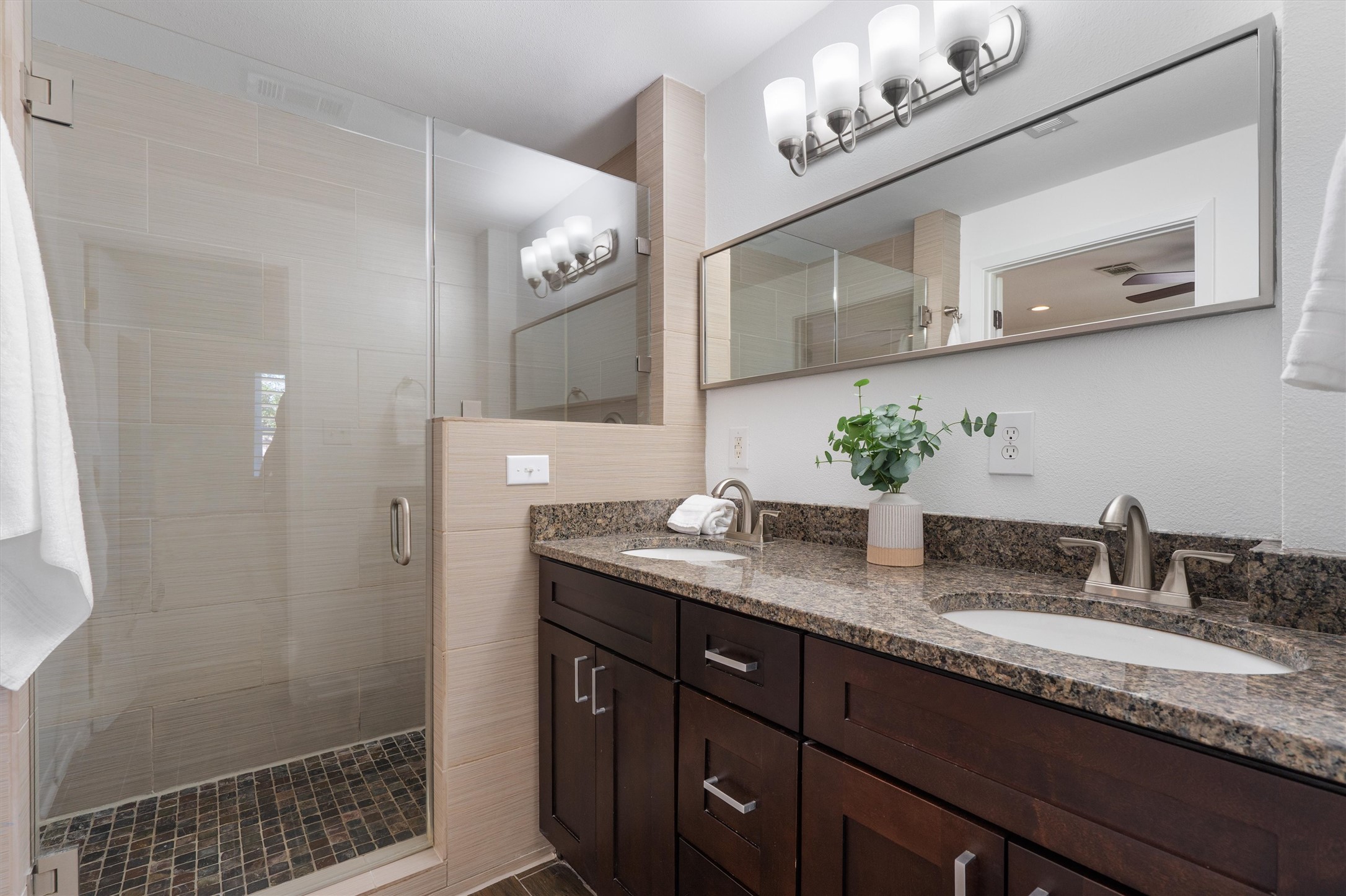 1904 Morrow Street Austin, TX 78757 - Photo 20 of 28 The ensuite features a granite dual vanity and oversized walk-in shower with floor to ceiling tile surround, enclosed by frameless glass.