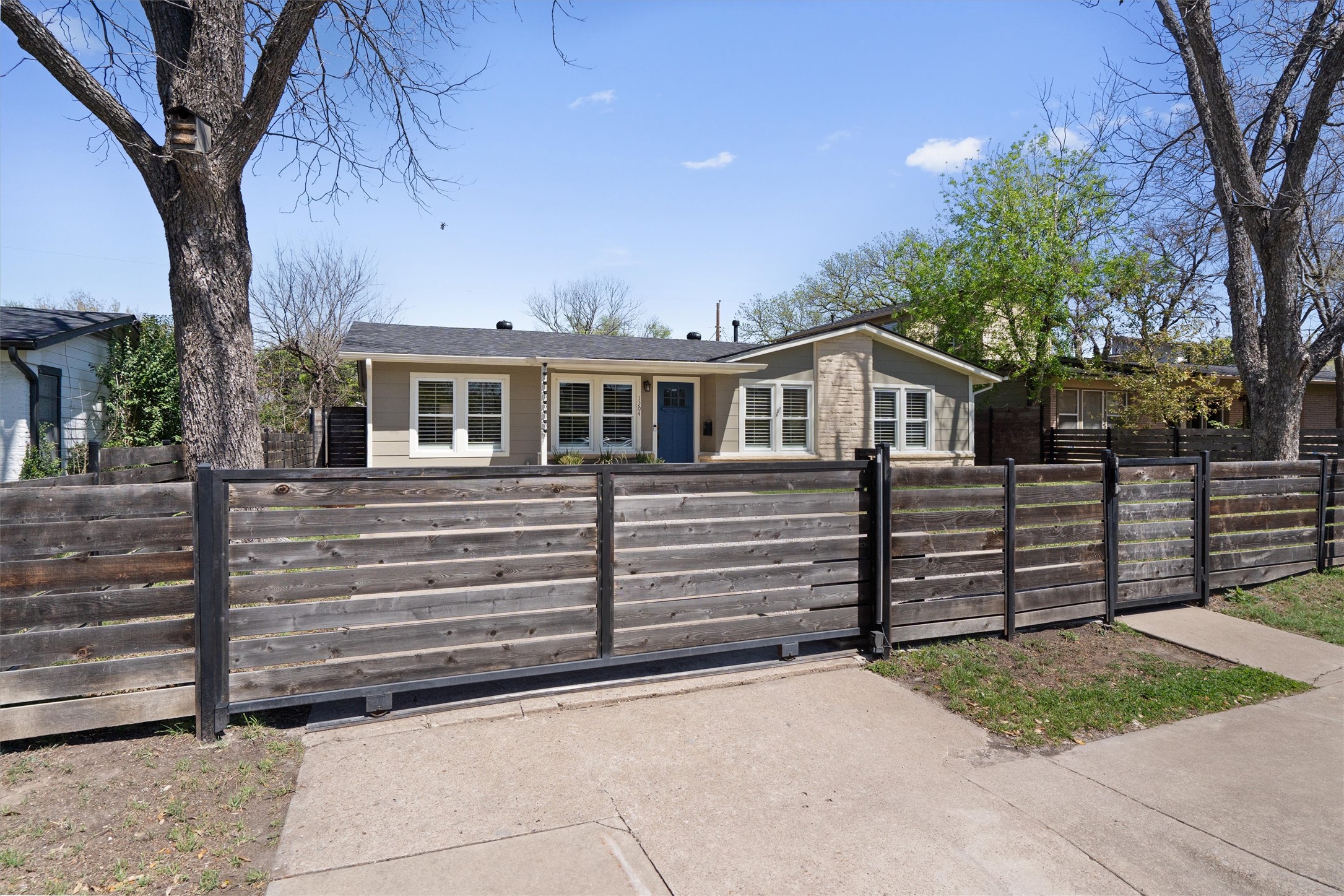1904 Morrow Street Austin, TX 78757 - Photo 4 of 28 The front gate adds both function and style, giving the home a private and polished presence.