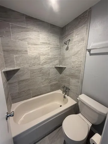 a bathroom with a toilet and a bathtub