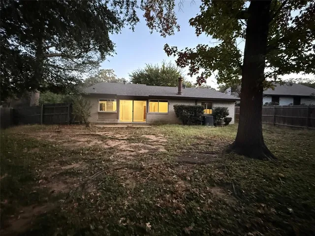 a view of a house with yard and sitting area