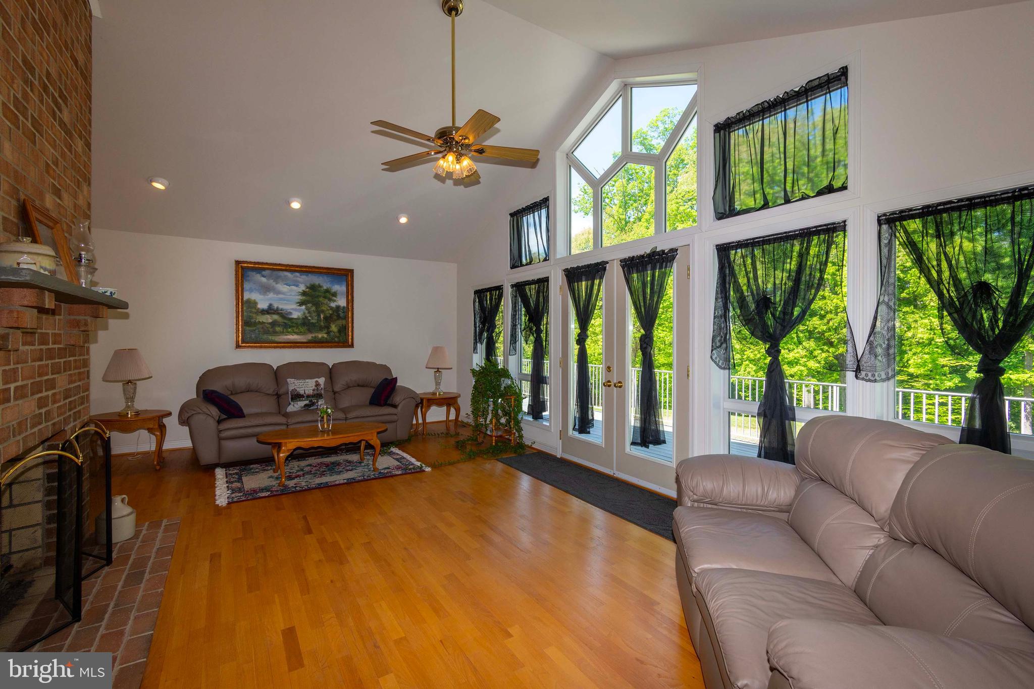 6000 Haleys Mill Road Spotsylvania, VA 22551 - Photo 18 of 85 a living room with furniture floor to ceiling window and a flat screen tv
