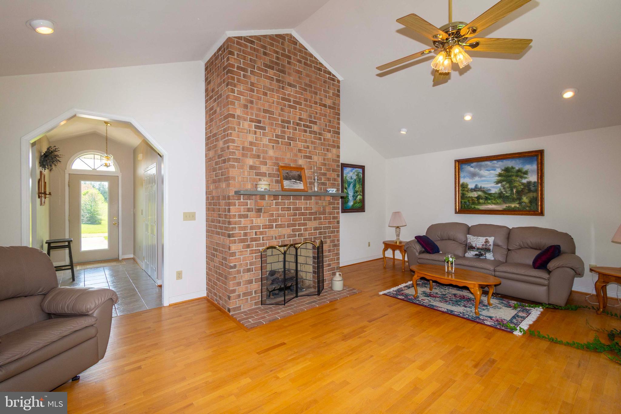 6000 Haleys Mill Road Spotsylvania, VA 22551 - Photo 20 of 85 a living room with furniture a fireplace and a flat screen tv
