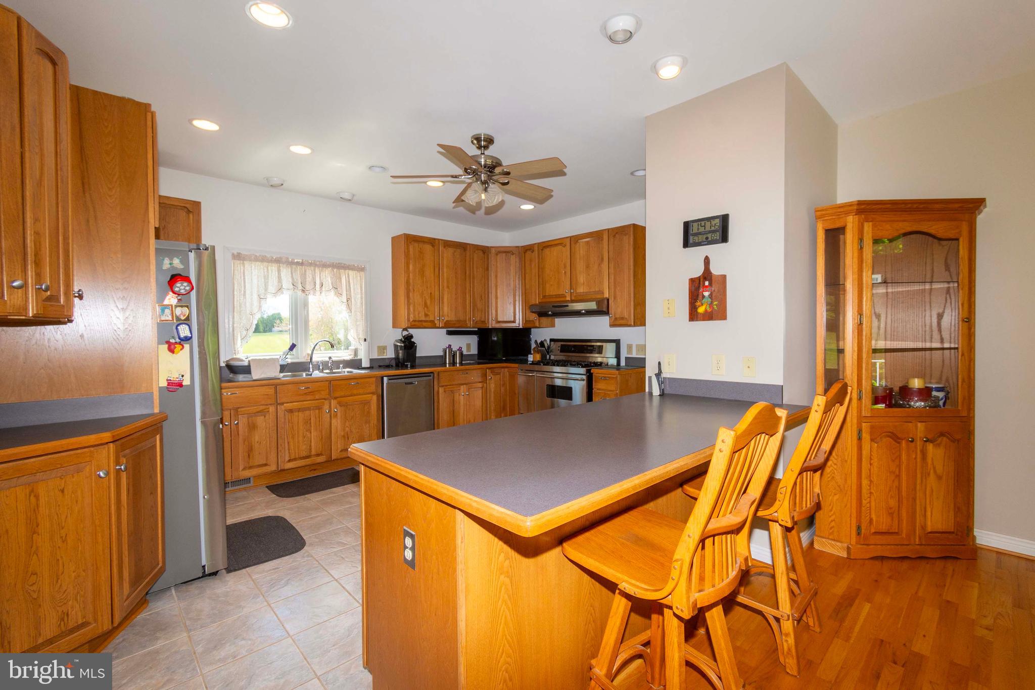 6000 Haleys Mill Road Spotsylvania, VA 22551 - Photo 27 of 85 a kitchen with stainless steel appliances kitchen island granite countertop a refrigerator a stove and a sink with granite countertops