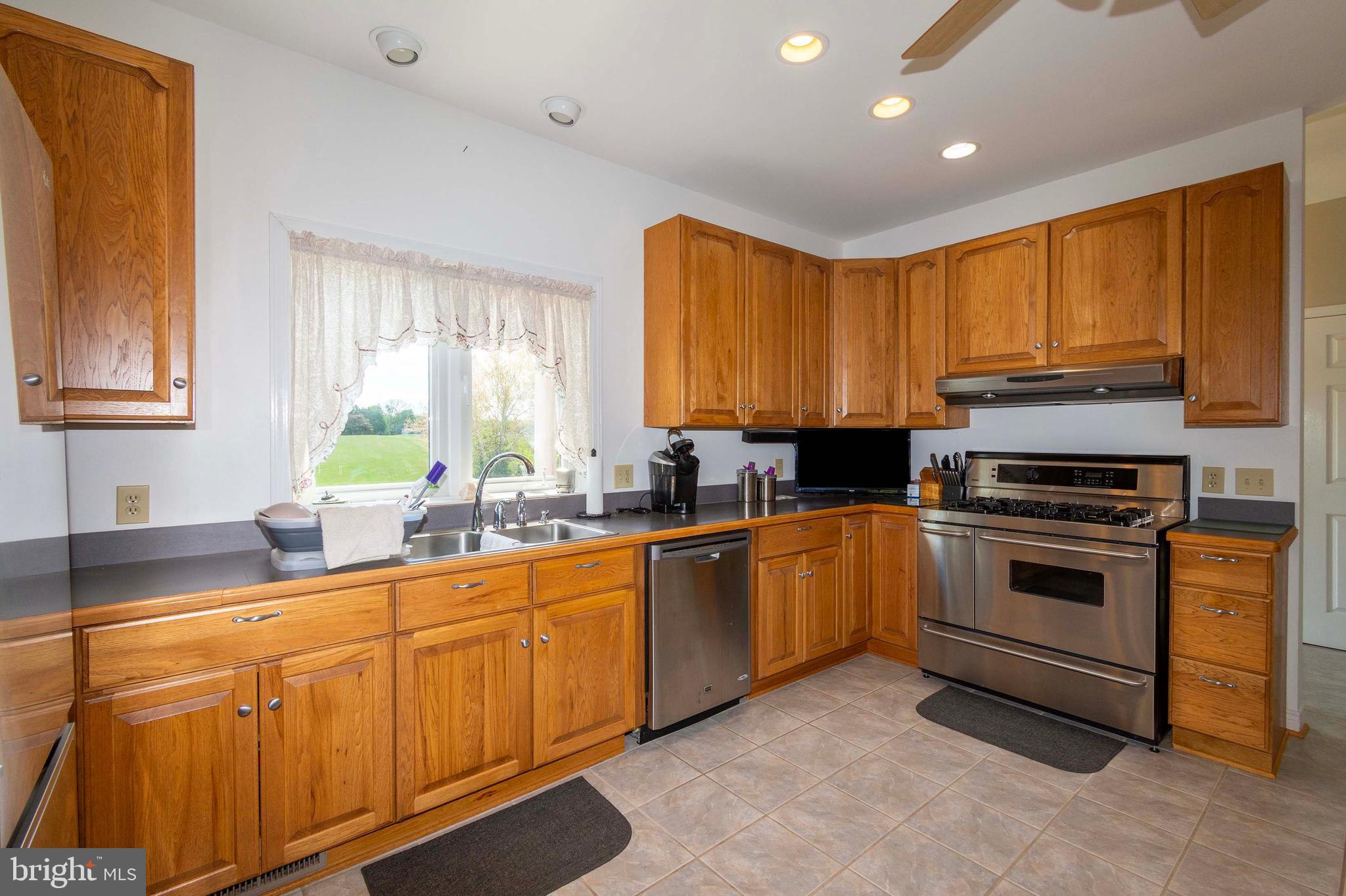 6000 Haleys Mill Road Spotsylvania, VA 22551 - Photo 30 of 85 a kitchen with stainless steel appliances granite countertop a stove a sink and a microwave