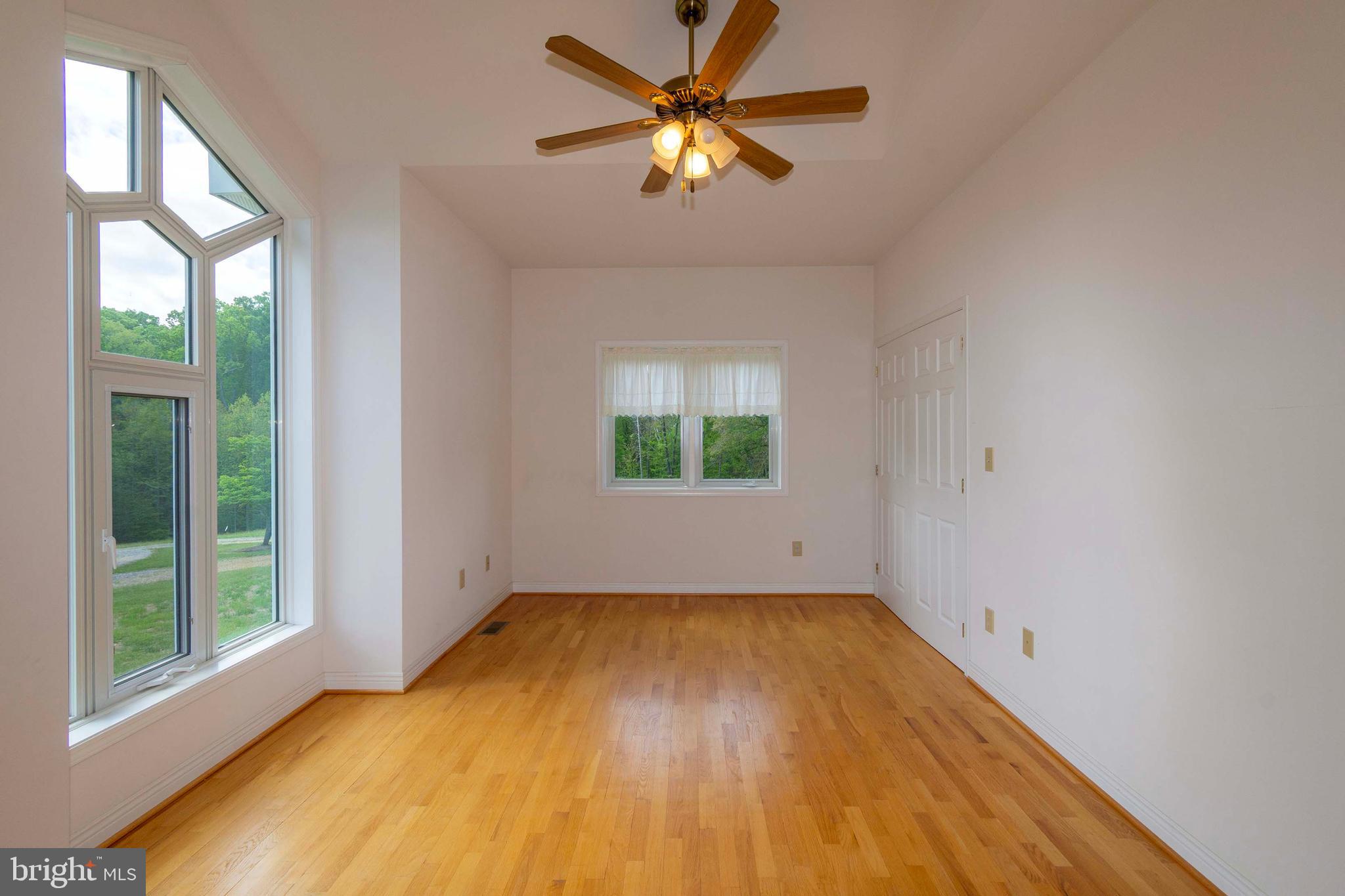 6000 Haleys Mill Road Spotsylvania, VA 22551 - Photo 37 of 85 a view of a room with window a ceiling fan and wooden floor