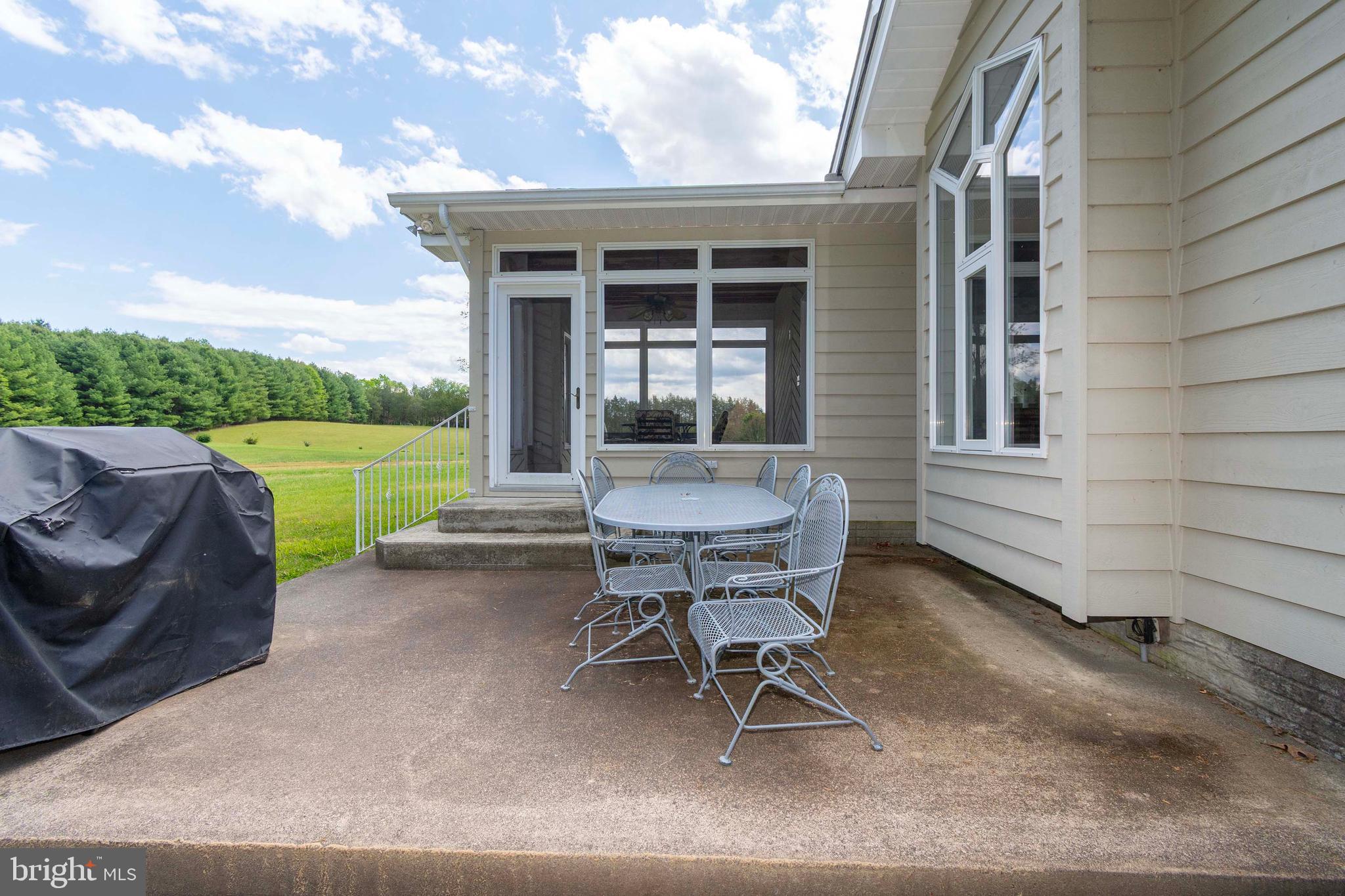 6000 Haleys Mill Road Spotsylvania, VA 22551 - Photo 83 of 85 a view of a backyard with table and chairs and a barbeque