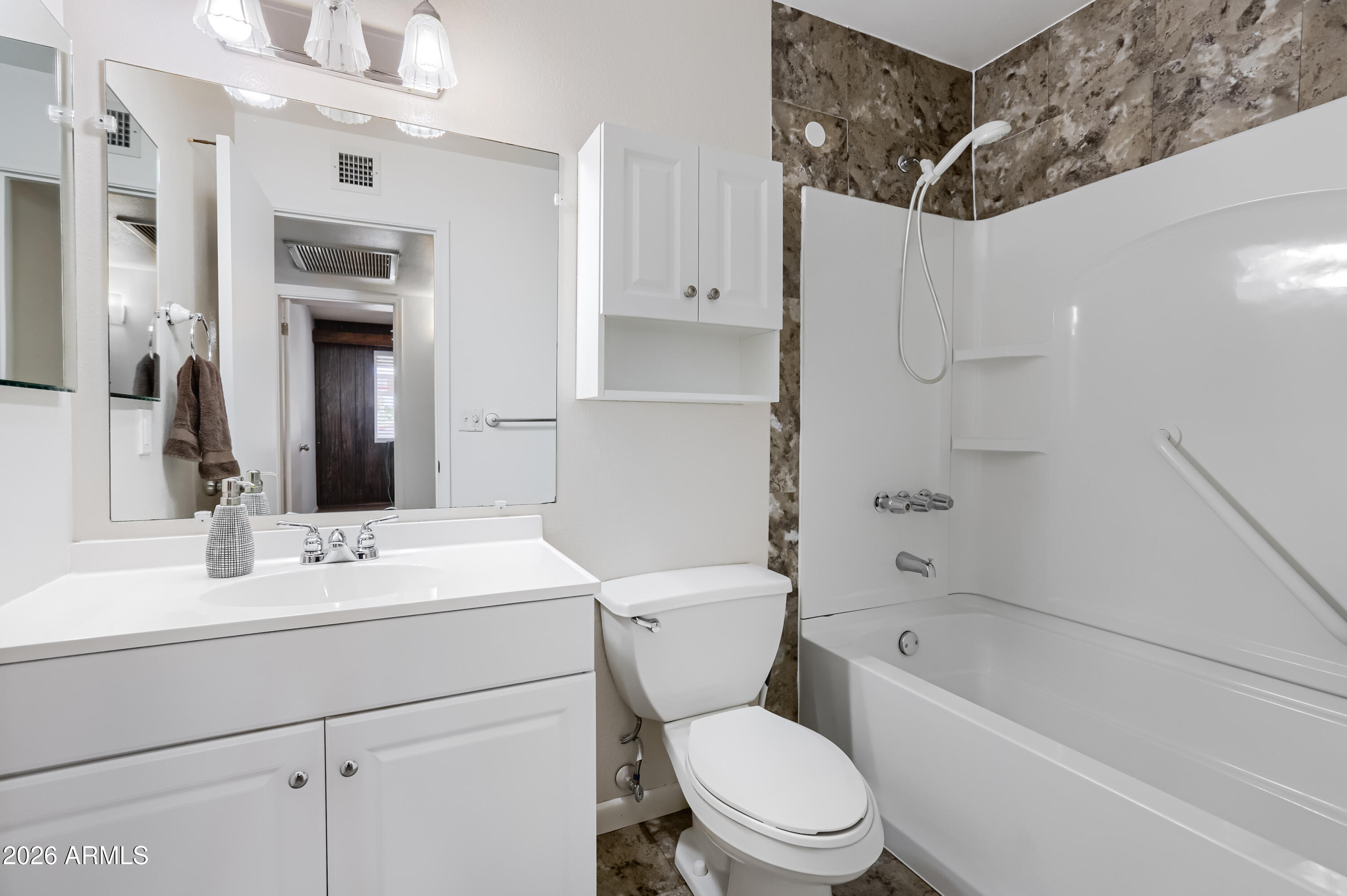 3823 West Greenway Road Phoenix, AZ 85053 - Photo 24 of 28 a bathroom with a sink toilet vanity and shower