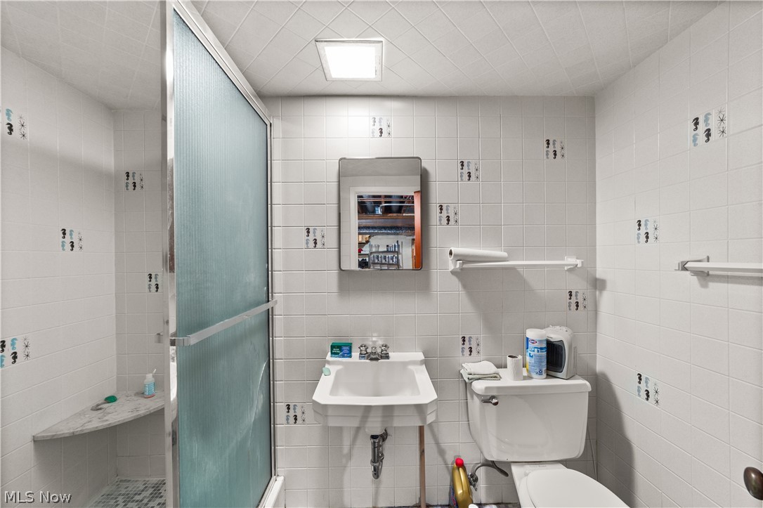 1730 Alcester Road Mayfield Heights, OH 44124 - Photo 26 of 39 Full bathroom with tiled shower and tile walls