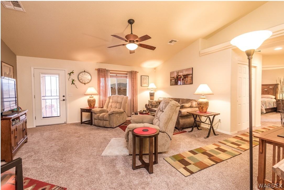 4292 East Cane Ranch Road Kingman, AZ 86401 - Photo 4 of 34 a living room with patio furniture and a chandelier