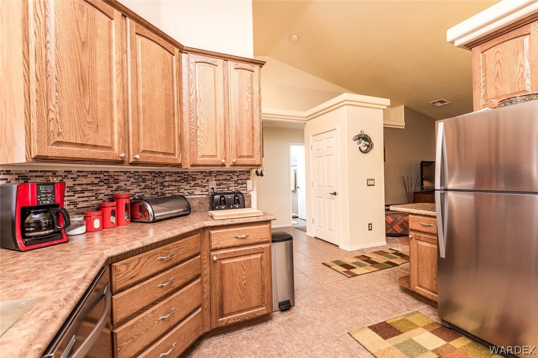 4292 East Cane Ranch Road Kingman, AZ 86401 - Photo 6 of 34 a kitchen with a refrigerator and cabinets