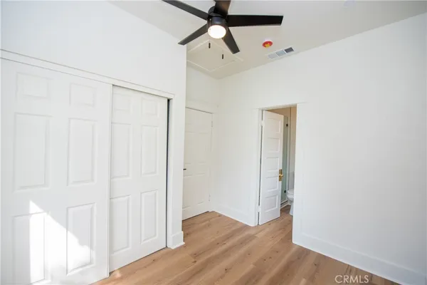a view of empty room with wooden floor