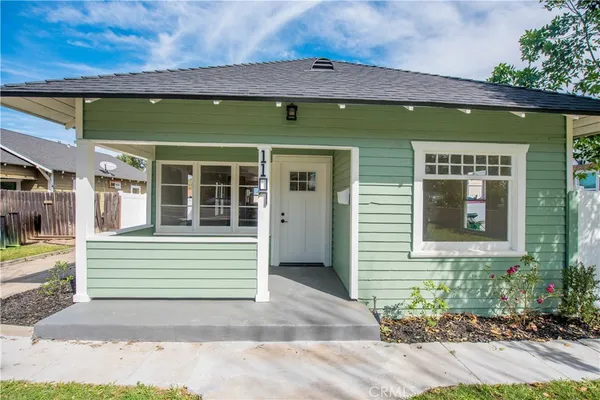 a front view of a house with garden
