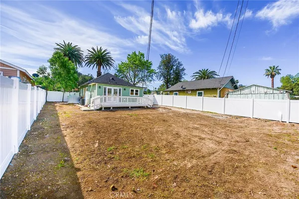 a view of a house with wooden floor and a yard