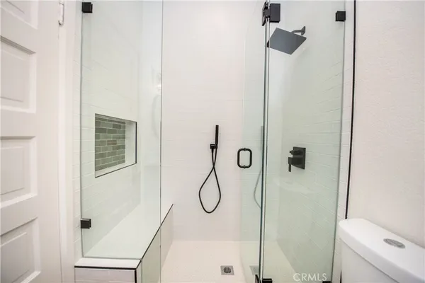 a bathroom with a glass shower door
