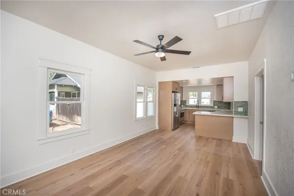 a view of kitchen with windows and ceiling fan