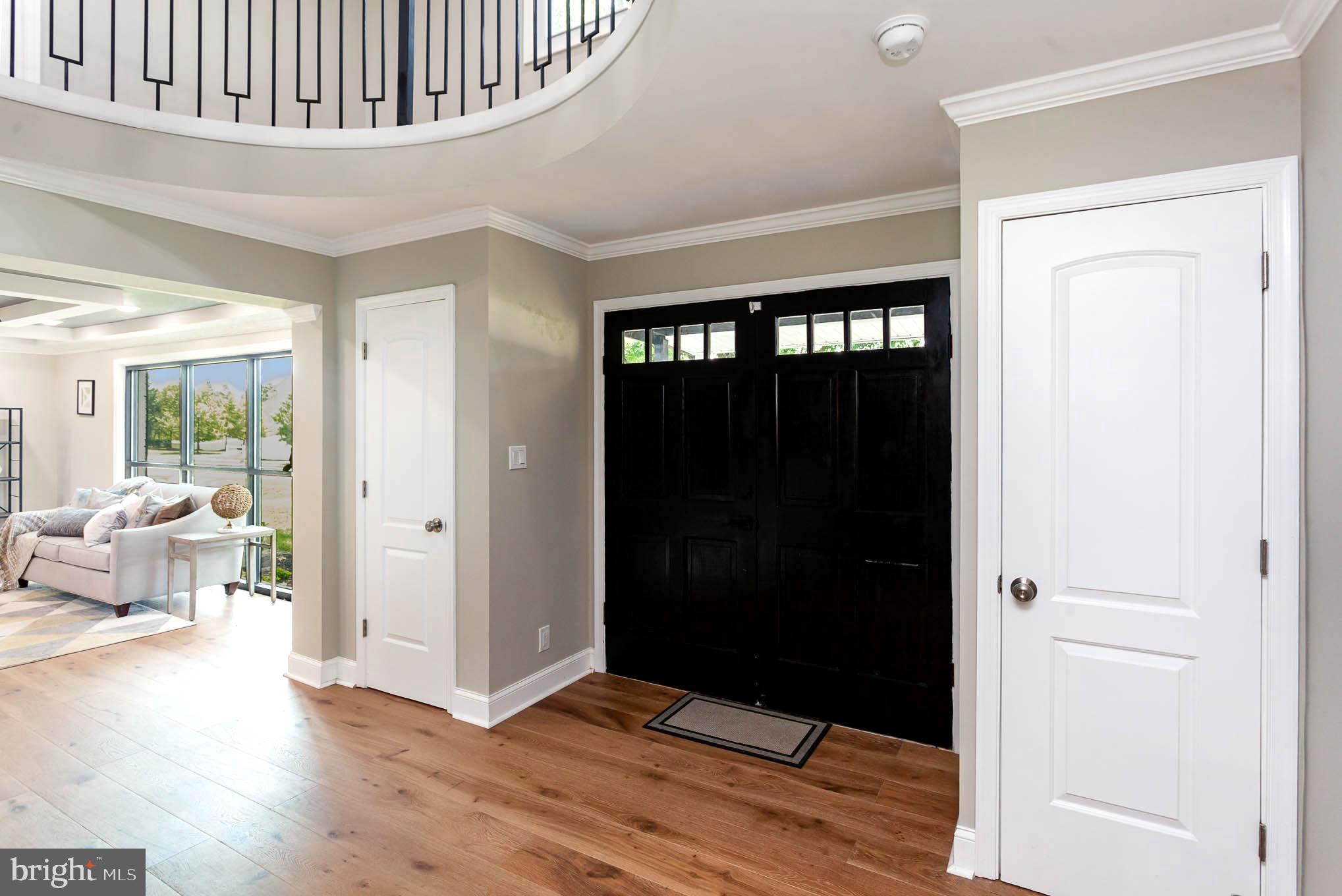 Double front door flanked by coat closets