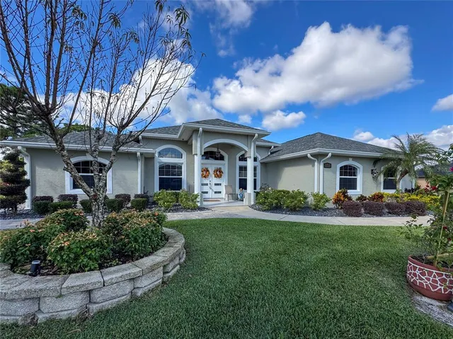 a front view of a house with garden and porch