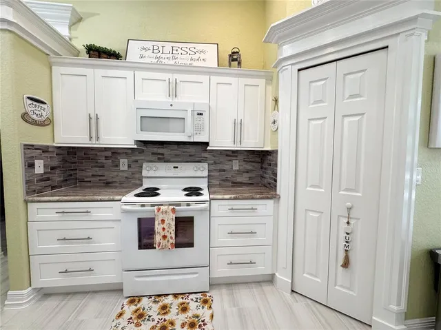 a kitchen with stainless steel appliances granite countertop a stove and a refrigerator