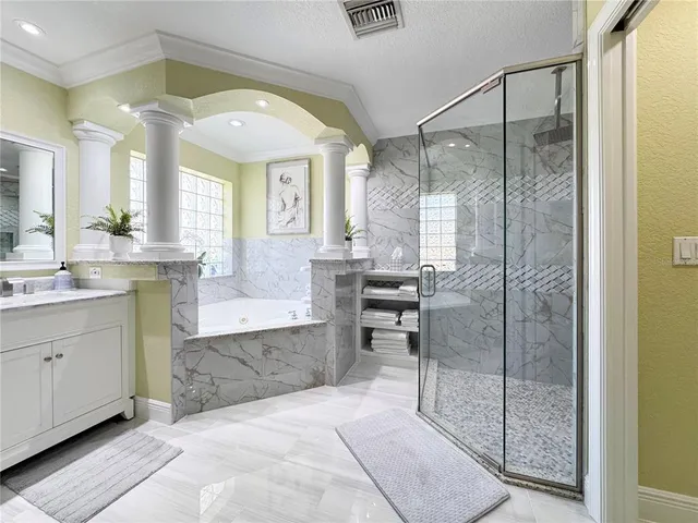 a spacious bathroom with a glass shower door and a sink