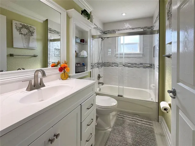 a bathroom with a sink toilet tub and shower