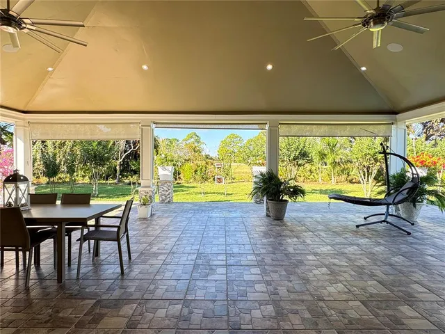 a view of a porch with chairs and backyard